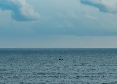 A small boat alone on the calm Bay of Bengal