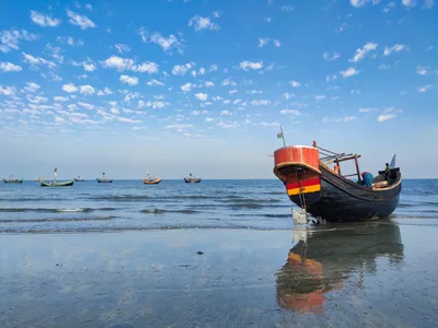A red fishing boat at low tide off Saint Martin's Island